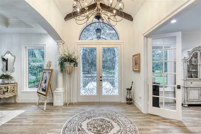 a bedroom with a bed and a large window with the outer view