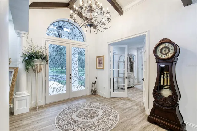 a living room with furniture and a floor to ceiling window