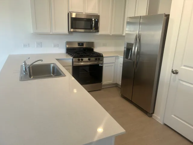 a kitchen with a refrigerator stove and microwave