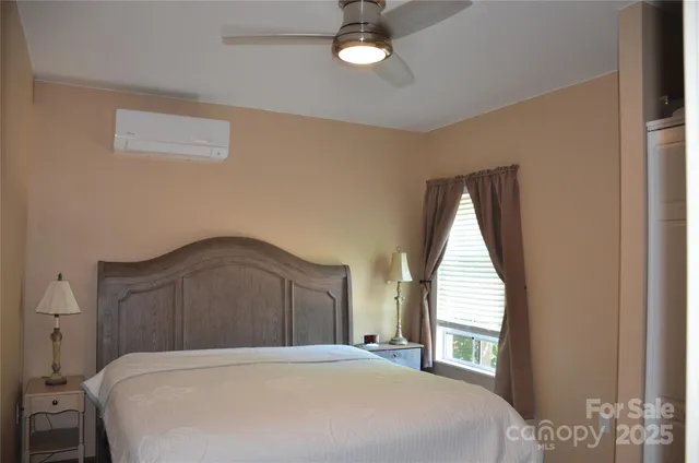 a bedroom with a large bed and a window