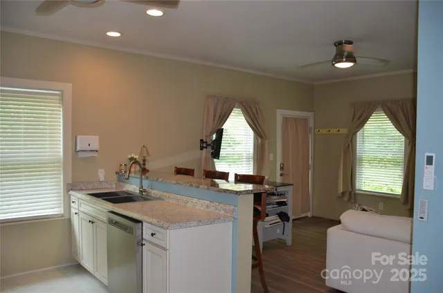 a kitchen with a sink and living room