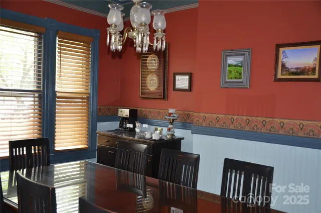 a view of a dining room with furniture and chandelier