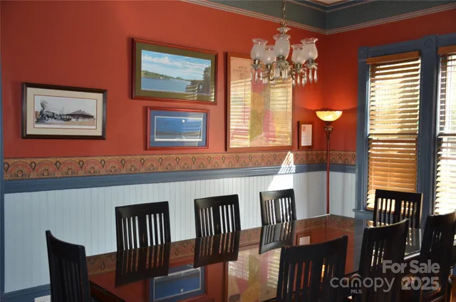 a view of a dining room with furniture and chandelier