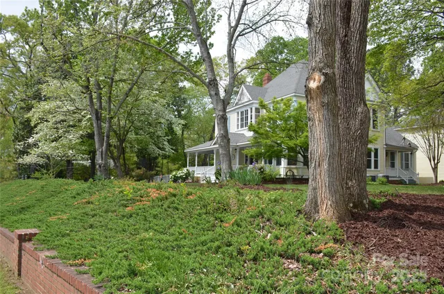a view of backyard of house with green space