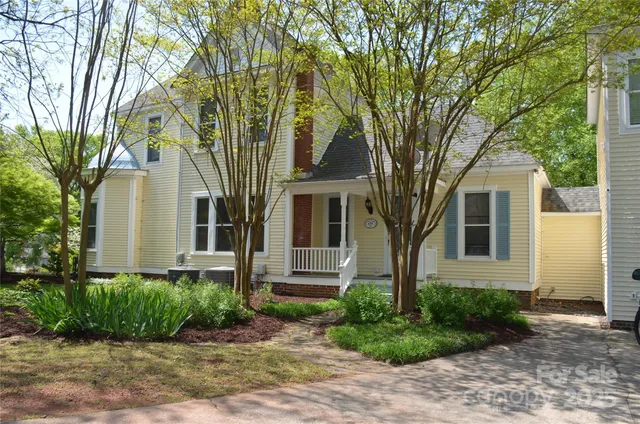front view of a house with a tree