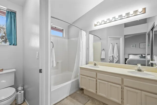 a bedroom with furniture and a window