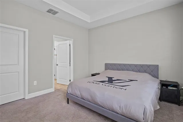 a bedroom with a bed and a night stand