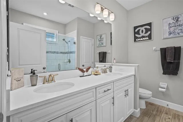 a bathroom with a sink a toilet and a mirror