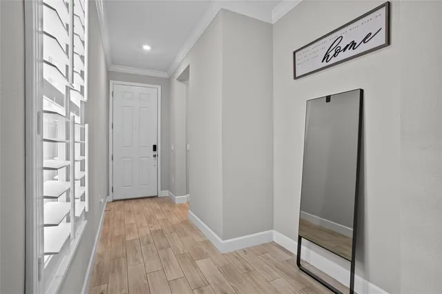 a view of hallway with wooden floor