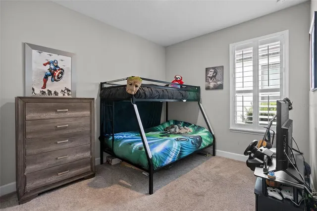 a bedroom with a bed and a baby crib