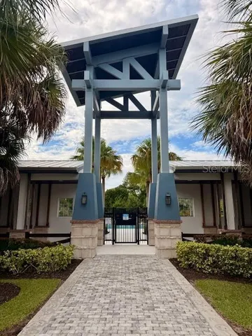 a view of a swimming pool with a table and chairs under an umbrella