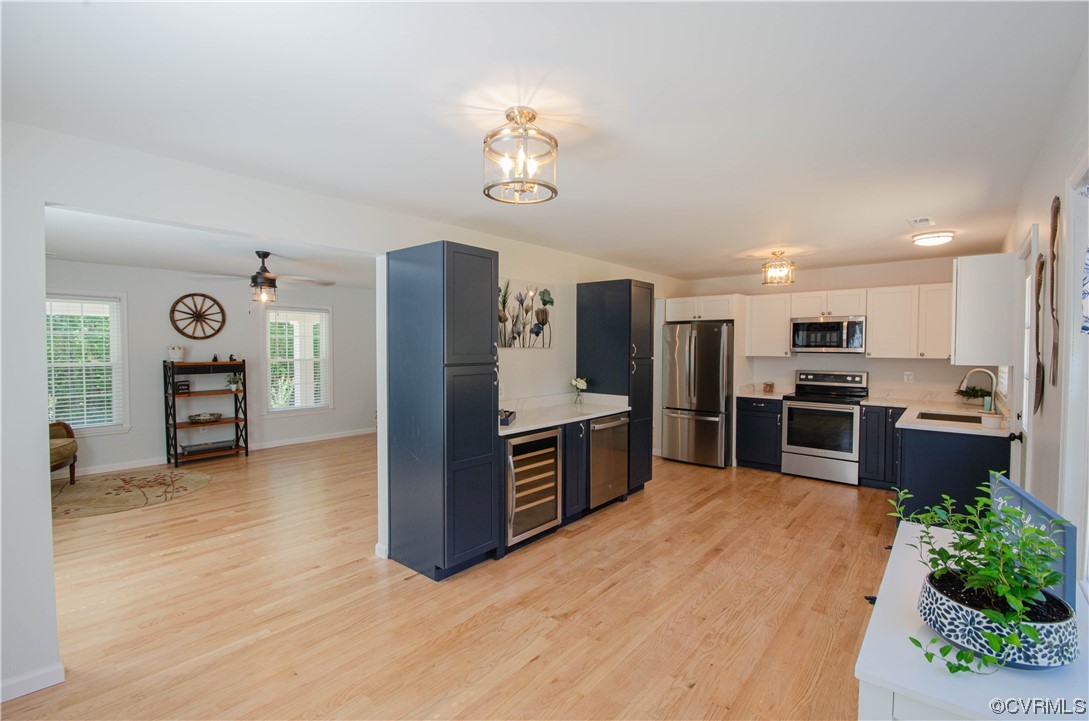 15073 Neck Trail Doswell, VA 23047 - Photo 12 of 50 a kitchen with stainless steel appliances granite countertop a refrigerator a stove oven a sink with dining table and chairs