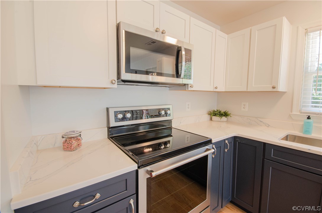 15073 Neck Trail Doswell, VA 23047 - Photo 17 of 50 a kitchen with a stove microwave and sink