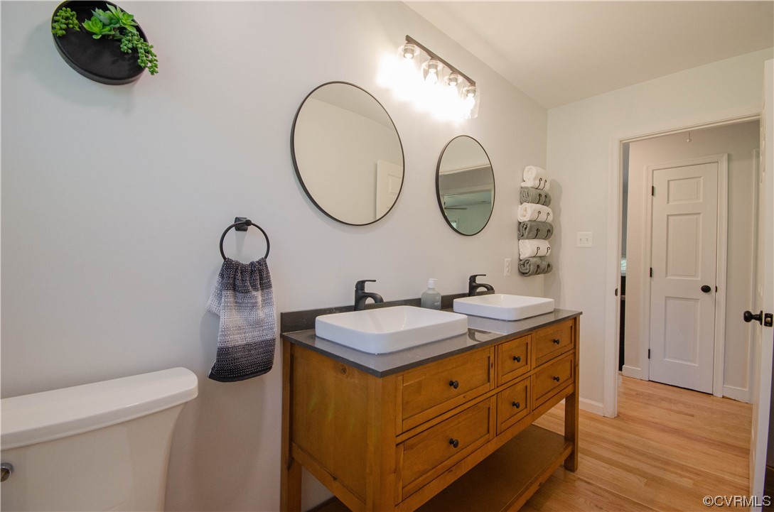 15073 Neck Trail Doswell, VA 23047 - Photo 23 of 50 a bathroom with a granite countertop sink mirror and vanity