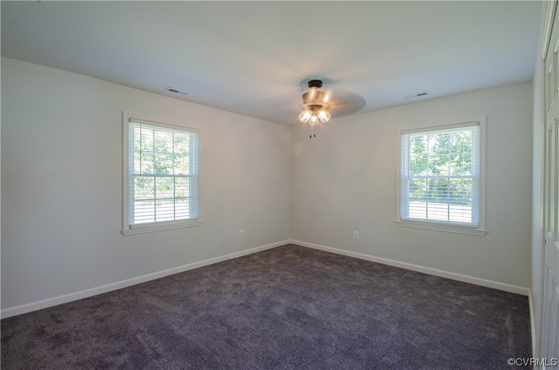 15073 Neck Trail Doswell, VA 23047 - Photo 24 of 50 an empty room with chandelier fan and windows
