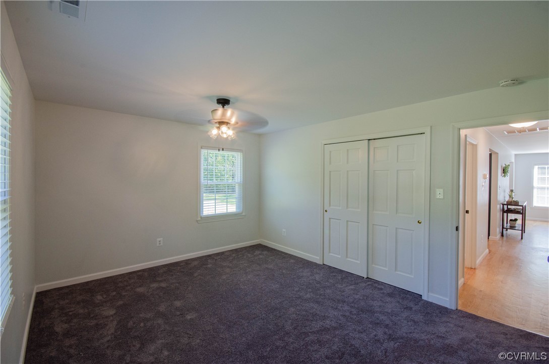 15073 Neck Trail Doswell, VA 23047 - Photo 25 of 50 an empty room with chandelier fan and windows