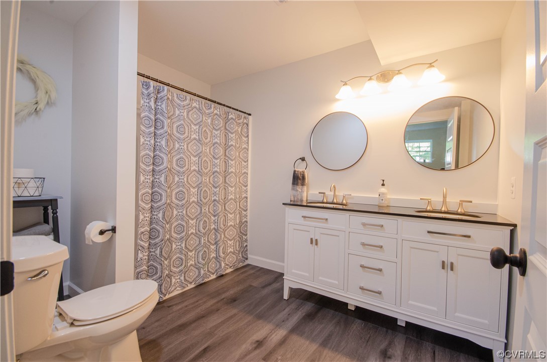 15073 Neck Trail Doswell, VA 23047 - Photo 34 of 50 a bathroom with a granite countertop toilet sink vanity and mirror