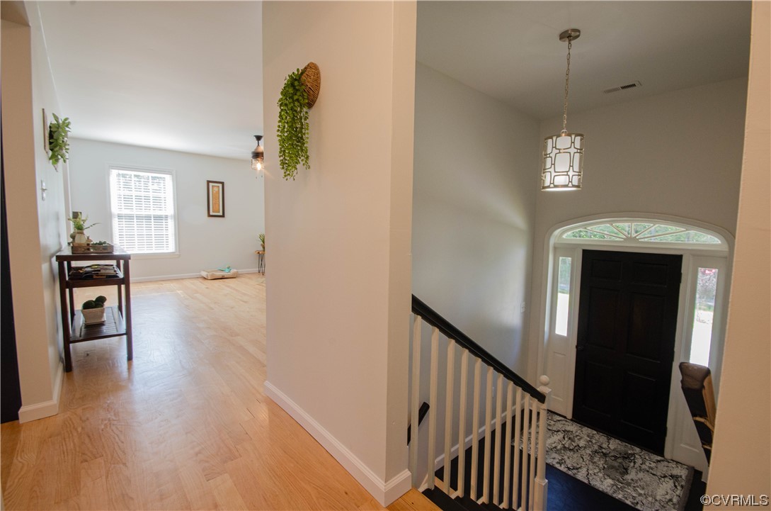 15073 Neck Trail Doswell, VA 23047 - Photo 6 of 50 a view of a hallway with wooden floor and dining room