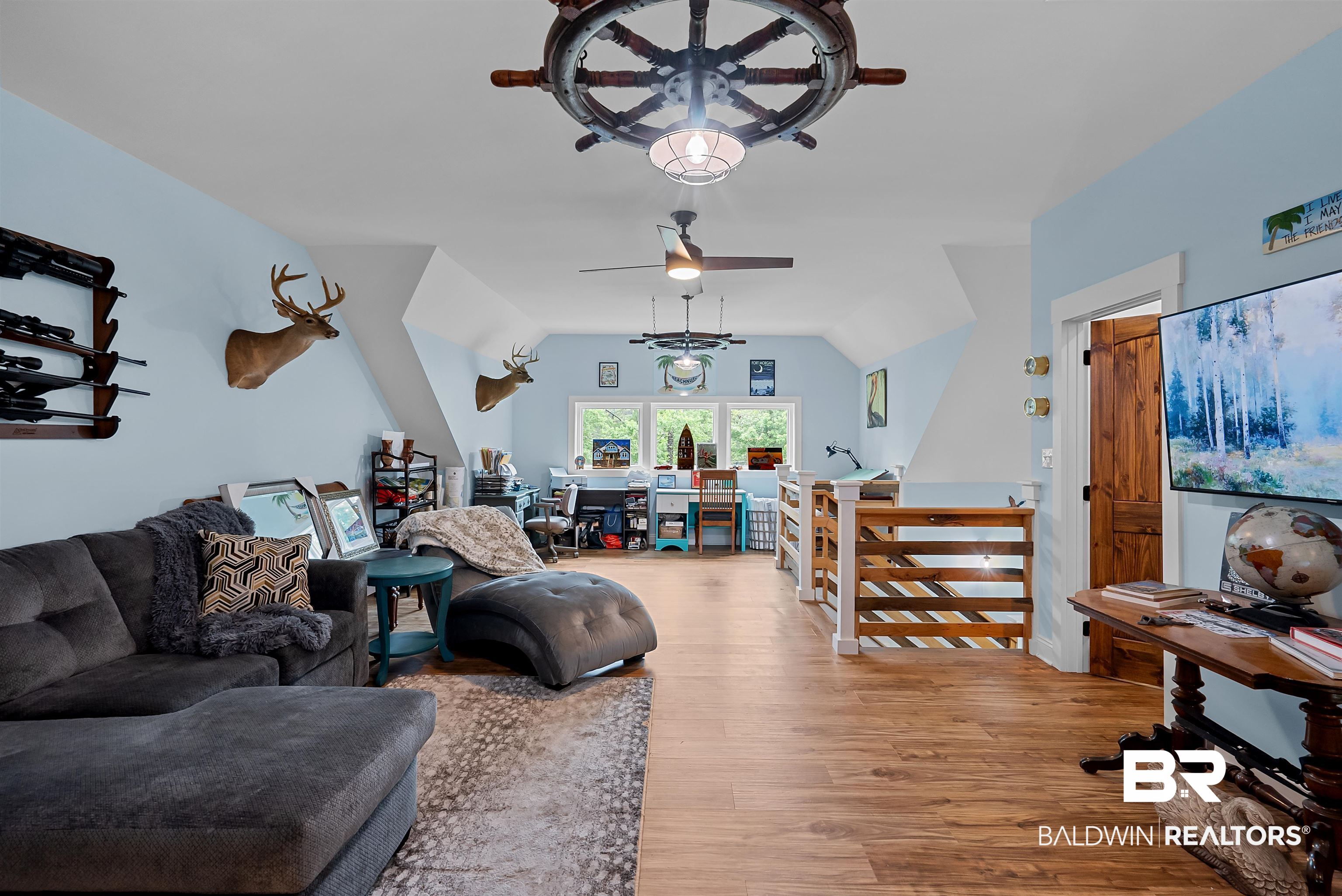 7266 Franklin Road Foley, AL 36535 - Photo 45 of 64 Spacious room with wood-finish flooring, light blue walls, and a vaulted ceiling