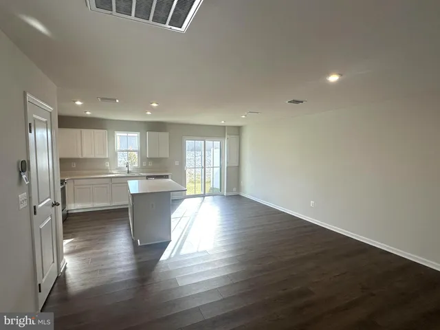 a view of kitchen with refrigerator and window