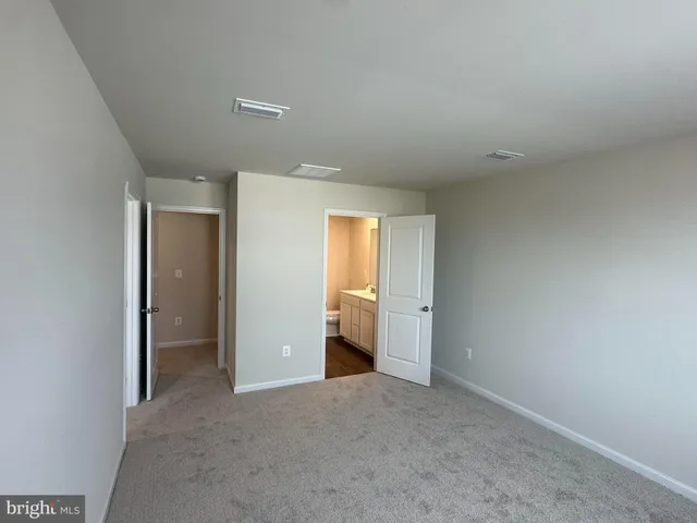 a view of an empty room and a window