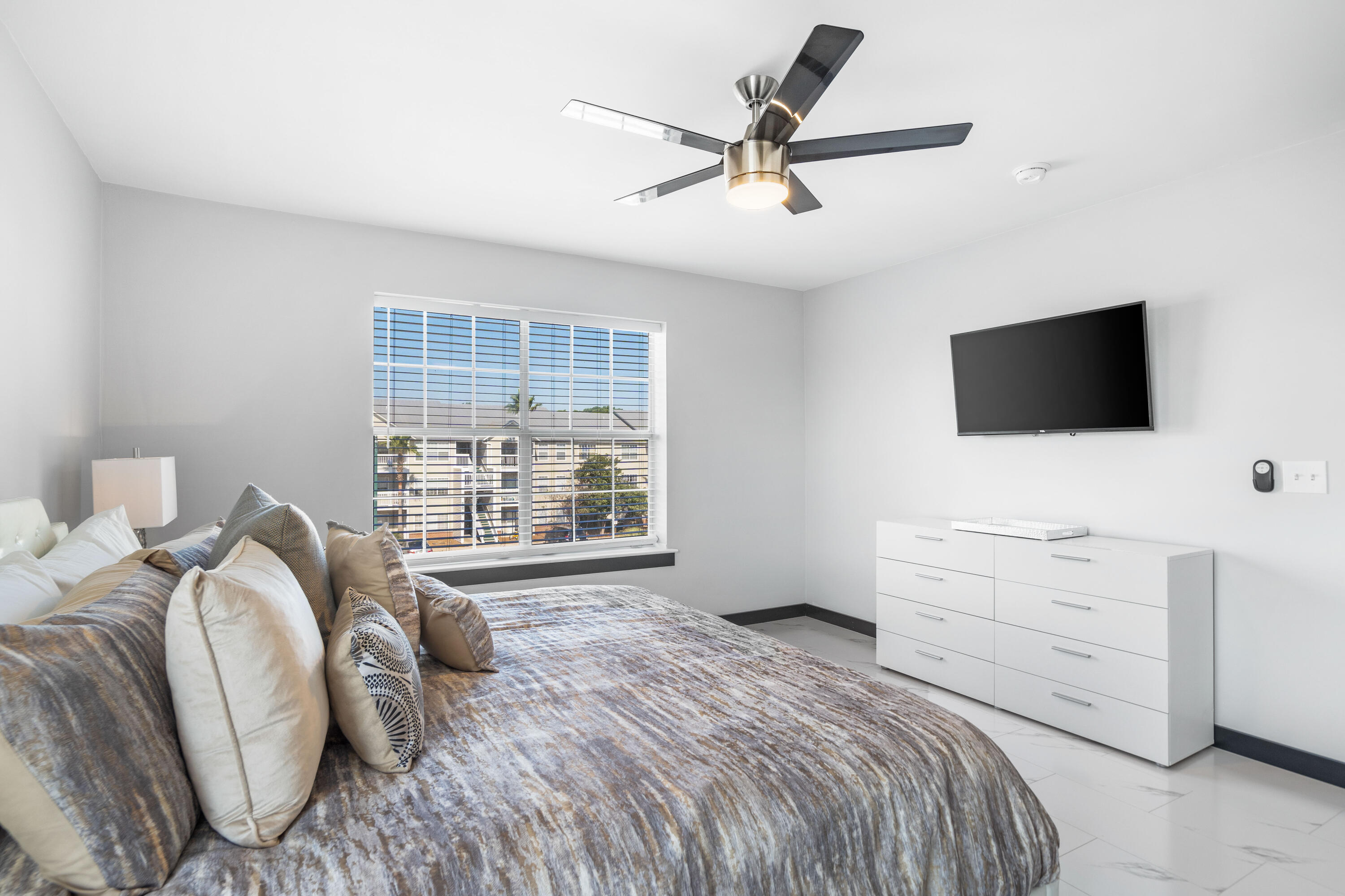 4100 Dancing Cloud Court, Unit 287 Destin, FL 32541 - Photo 12 of 26 a bedroom with a bed a window and a flat screen television