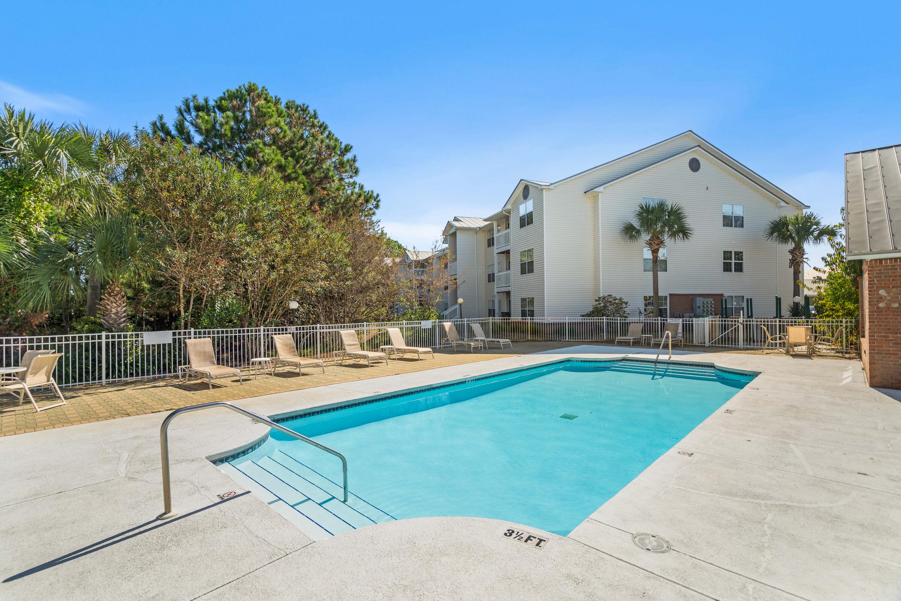4100 Dancing Cloud Court, Unit 287 Destin, FL 32541 - Photo 20 of 26 a view of a swimming pool with lounge chairs