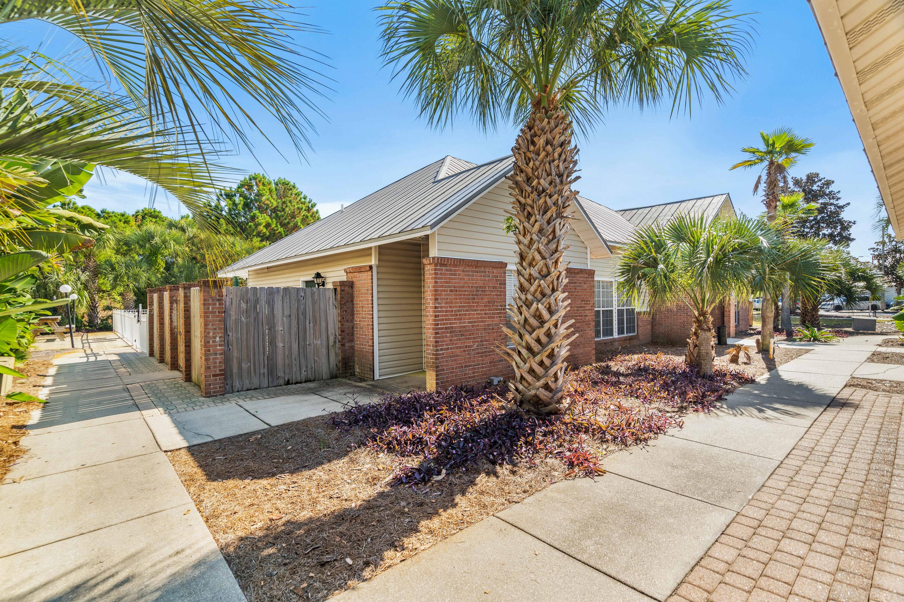 4100 Dancing Cloud Court, Unit 287 Destin, FL 32541 - Photo 25 of 26 a couple of palm trees in front of house