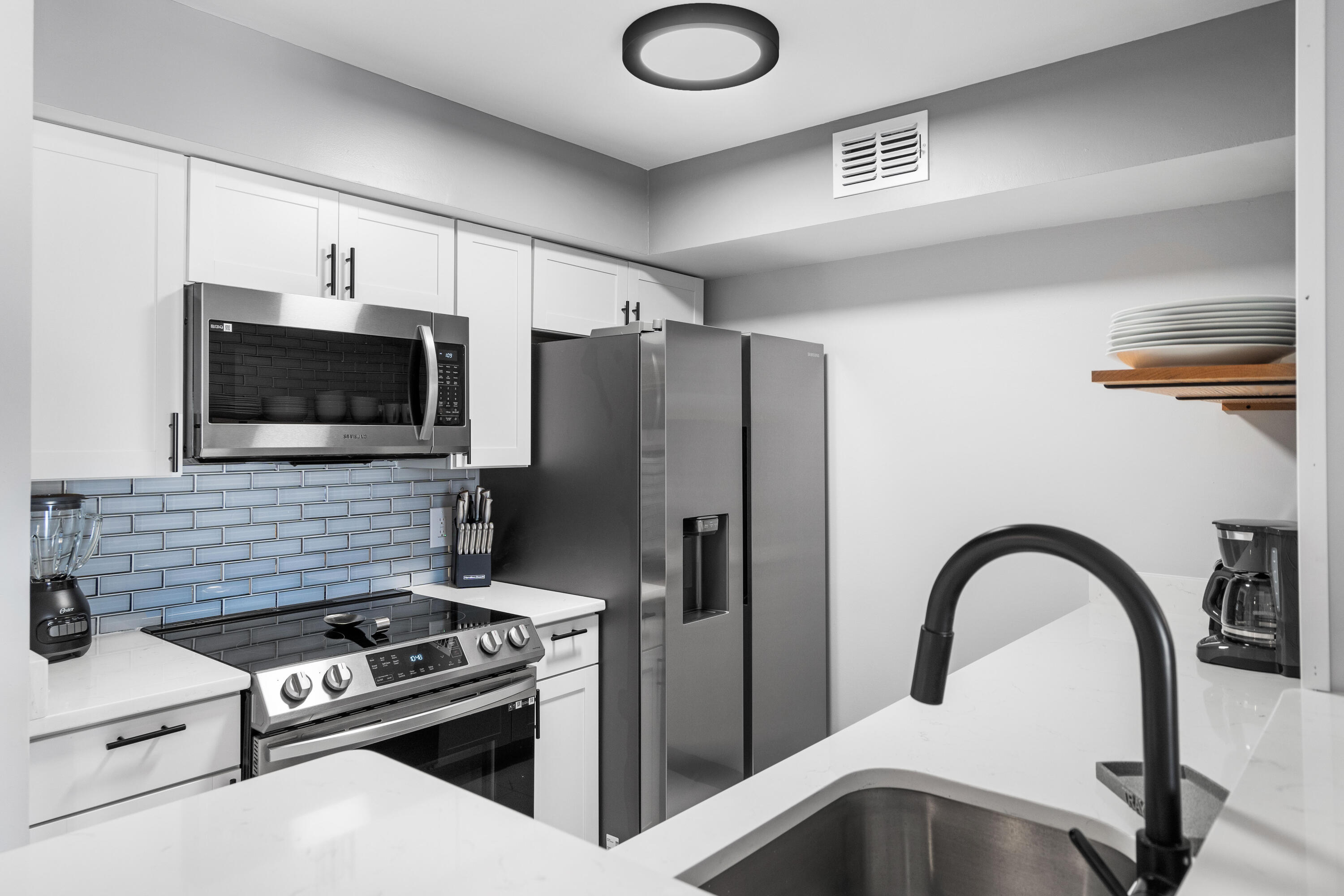 4100 Dancing Cloud Court, Unit 287 Destin, FL 32541 - Photo 6 of 26 a kitchen with granite countertop a stove and a refrigerator