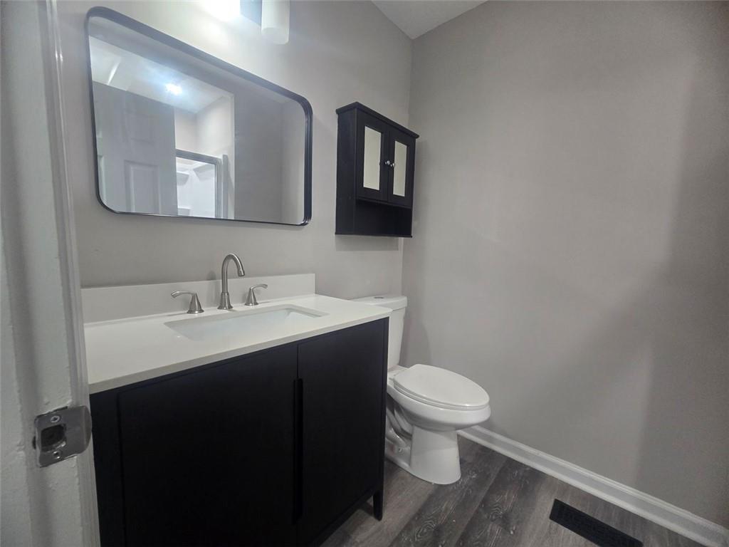4059 Canby Lane Decatur, GA 30035 - Photo 11 of 18 a bathroom with a toilet a sink and mirror