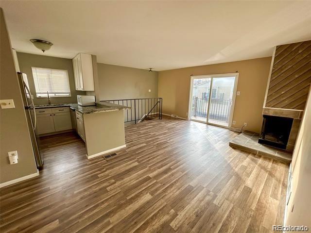 1225 South Oneida Street, Unit 252 Denver, CO 80224 - Photo 4 of 20 a view of a kitchen with furniture and a flat screen tv