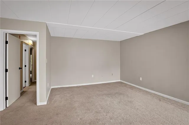 a view of a kitchen with a refrigerator and a sink