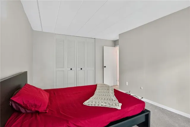 a bedroom with a bed and a closet