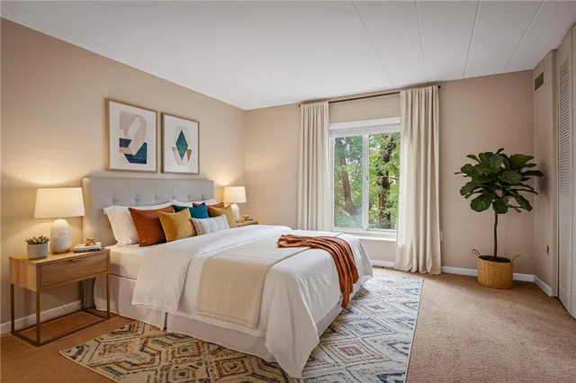 a bedroom with a bed and a window