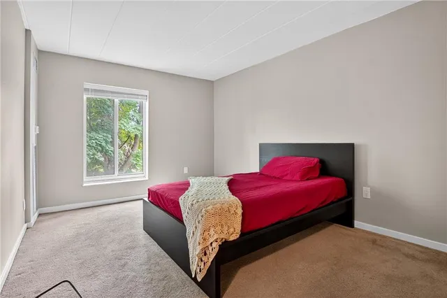 an empty room with chandelier and windows