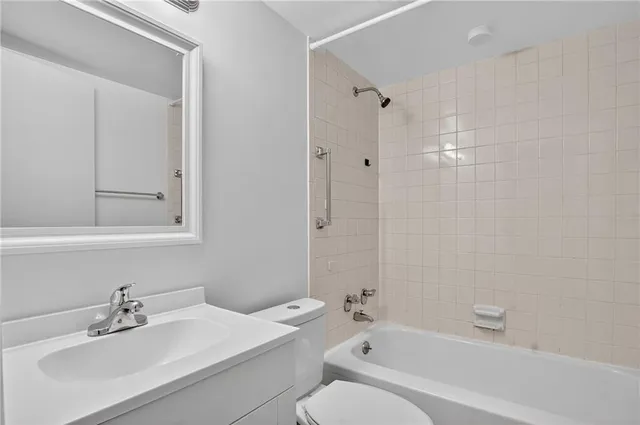 a view of a kitchen with a refrigerator cabinets and a ceiling fan