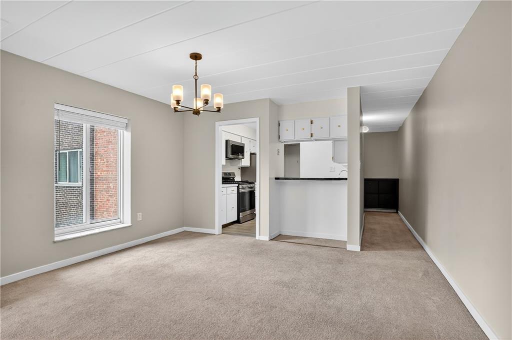 5 Bayard Road, Unit 500 Pittsburgh, PA 15213 - Photo 27 of 45 an empty room with chandelier and windows