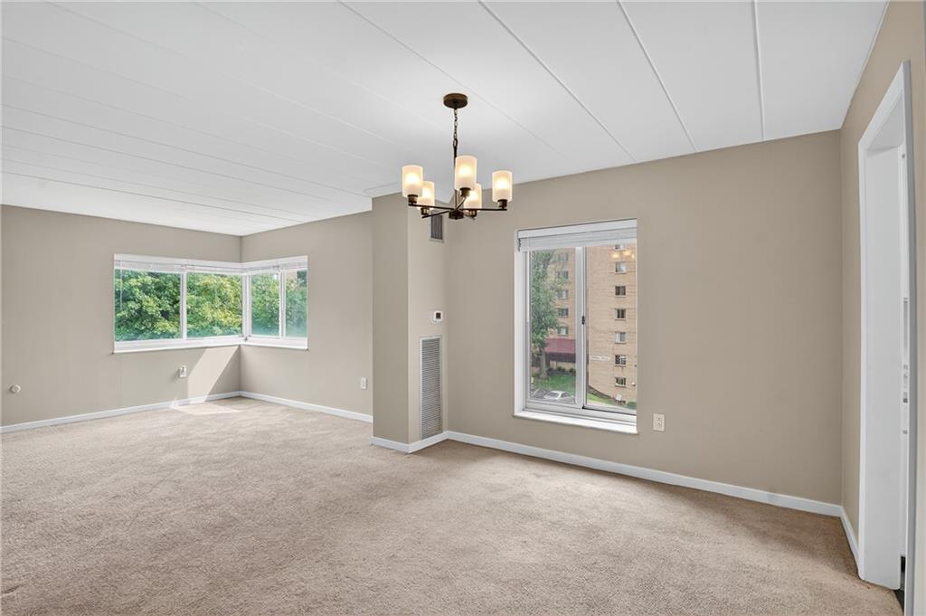 5 Bayard Road, Unit 500 Pittsburgh, PA 15213 - Photo 29 of 45 an empty room with windows and chandelier
