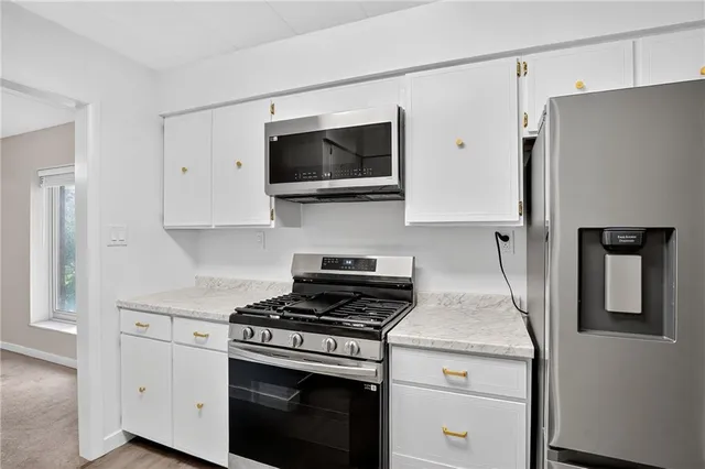 a kitchen with white cabinets and a sink