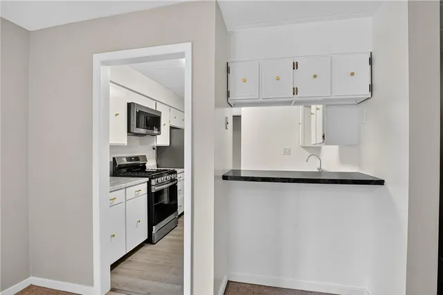 a kitchen with stainless steel appliances granite countertop a sink and cabinets