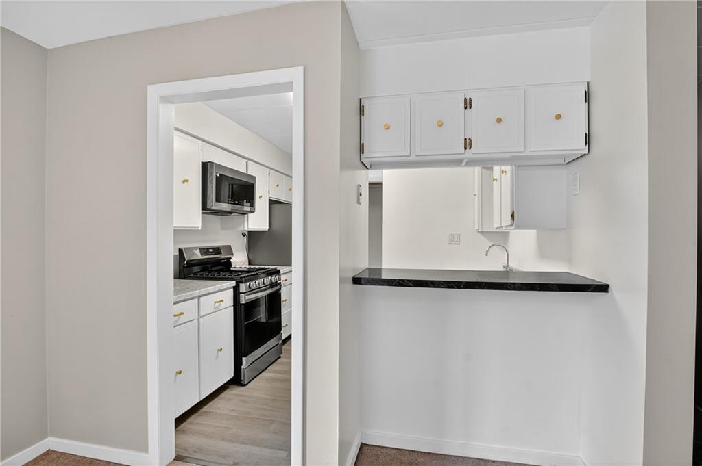 5 Bayard Road, Unit 500 Pittsburgh, PA 15213 - Photo 33 of 45 a kitchen with stainless steel appliances granite countertop a sink a stove and a refrigerator