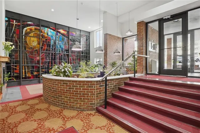a living room filled with furniture and a floor to ceiling window
