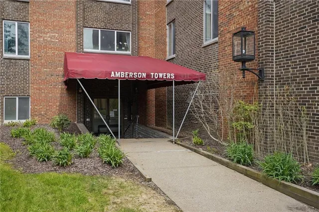 an aerial view of a house with yard swimming pool and lake view