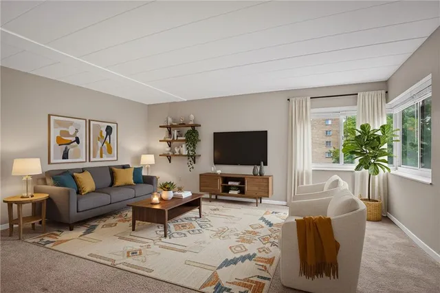 an empty room with a kitchen and a refrigerator