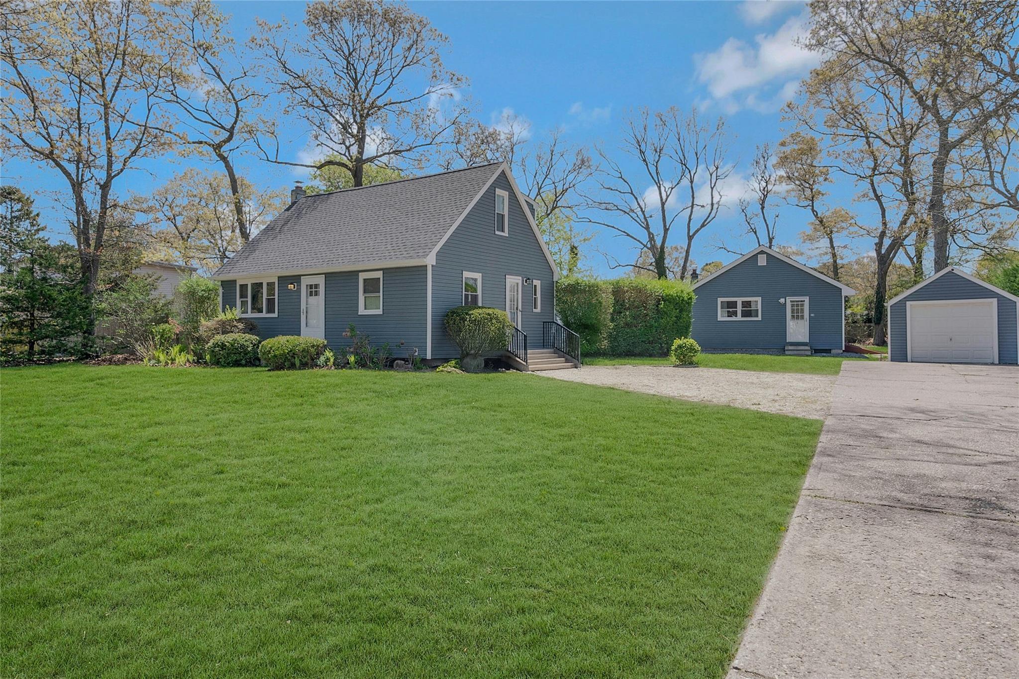 a front view of house with yard and green space