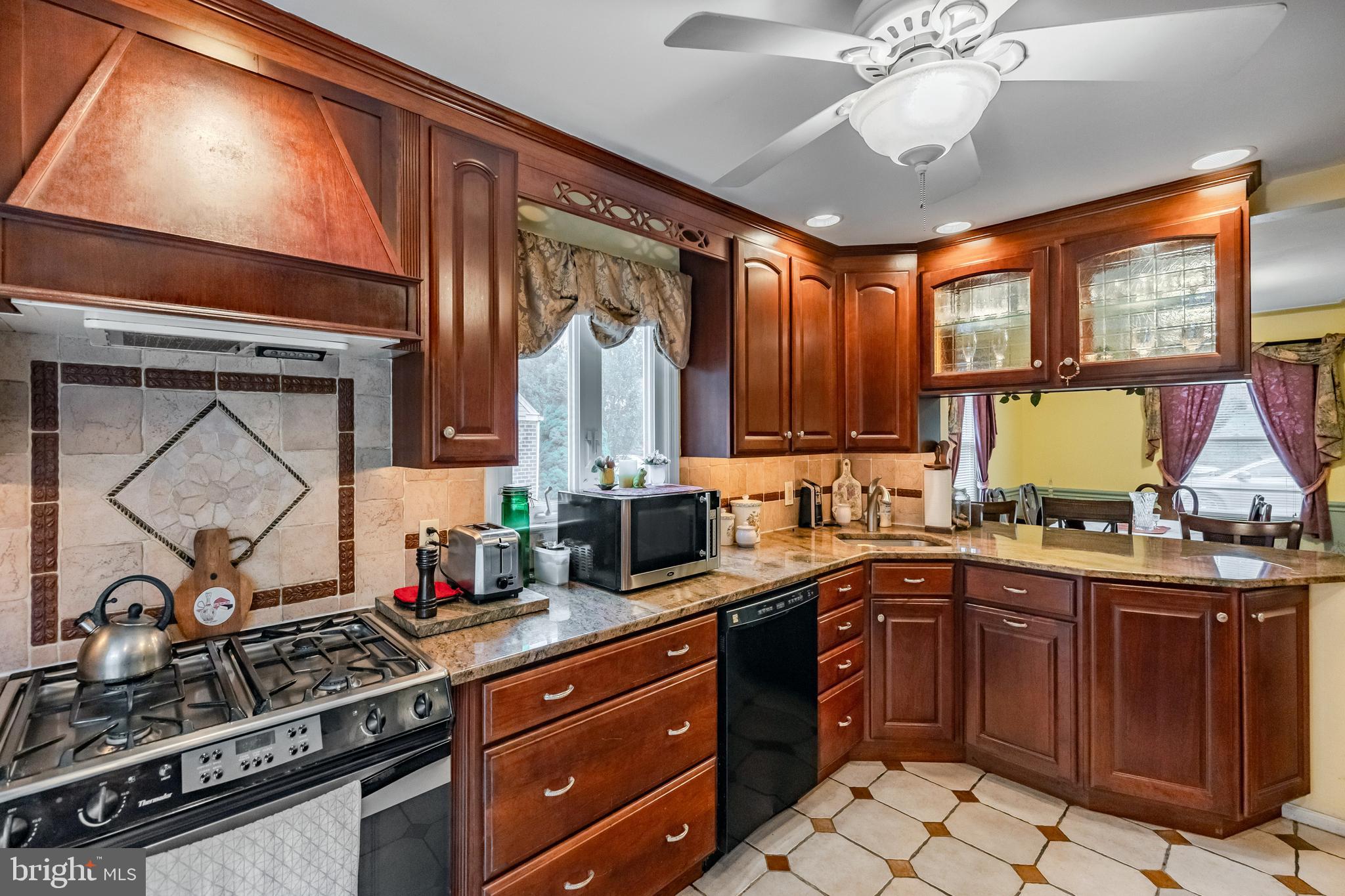212 Golf Hills Road Havertown, PA 19083 - Photo 1 of 37 a kitchen with a sink appliances cabinets and a large window