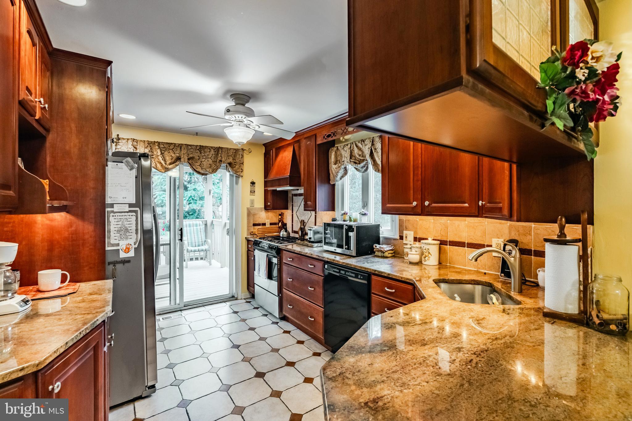 212 Golf Hills Road Havertown, PA 19083 - Photo 11 of 37 a kitchen with stainless steel appliances granite countertop a sink a stove and a refrigerator