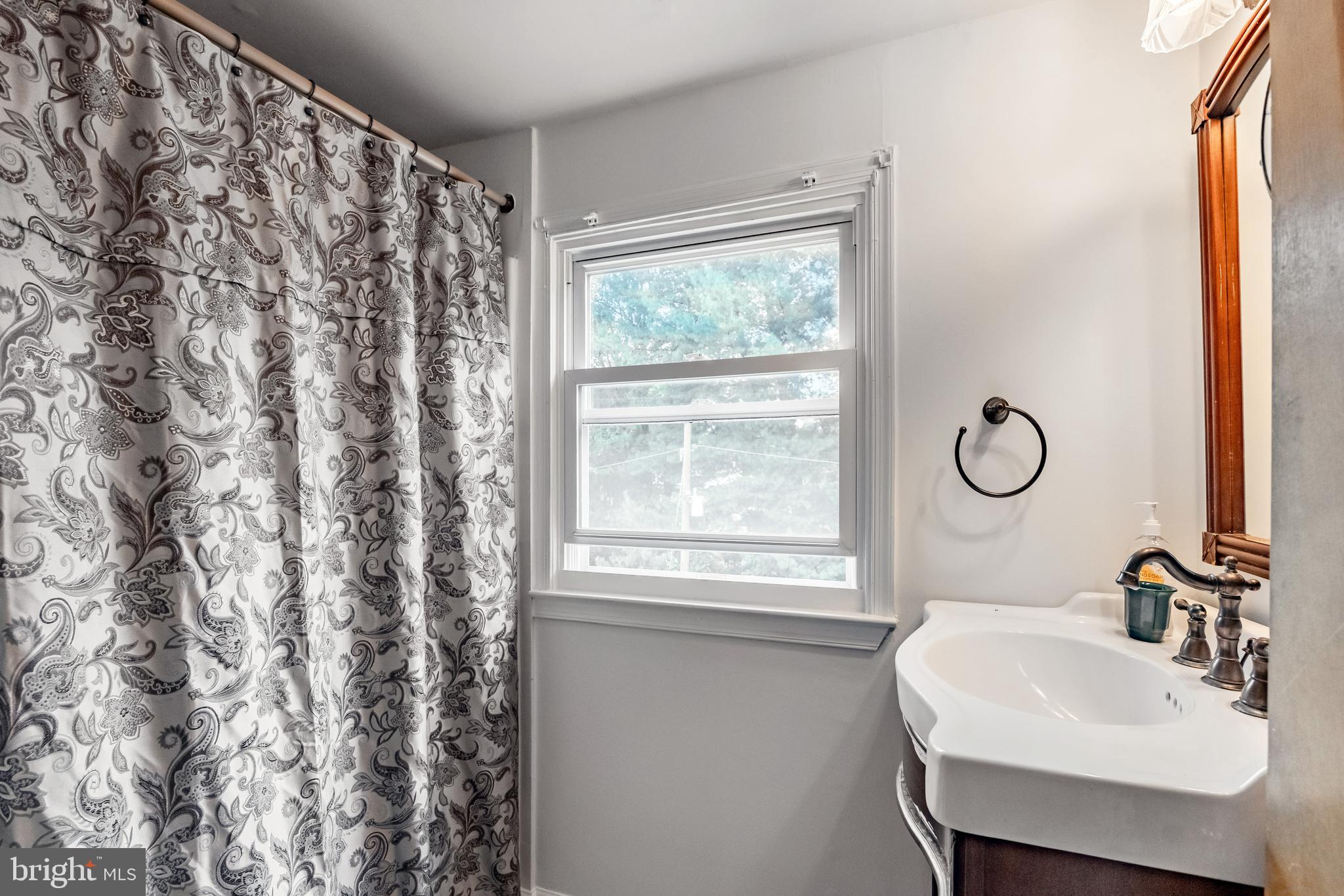 212 Golf Hills Road Havertown, PA 19083 - Photo 19 of 37 a bathroom with a sink toilet and window
