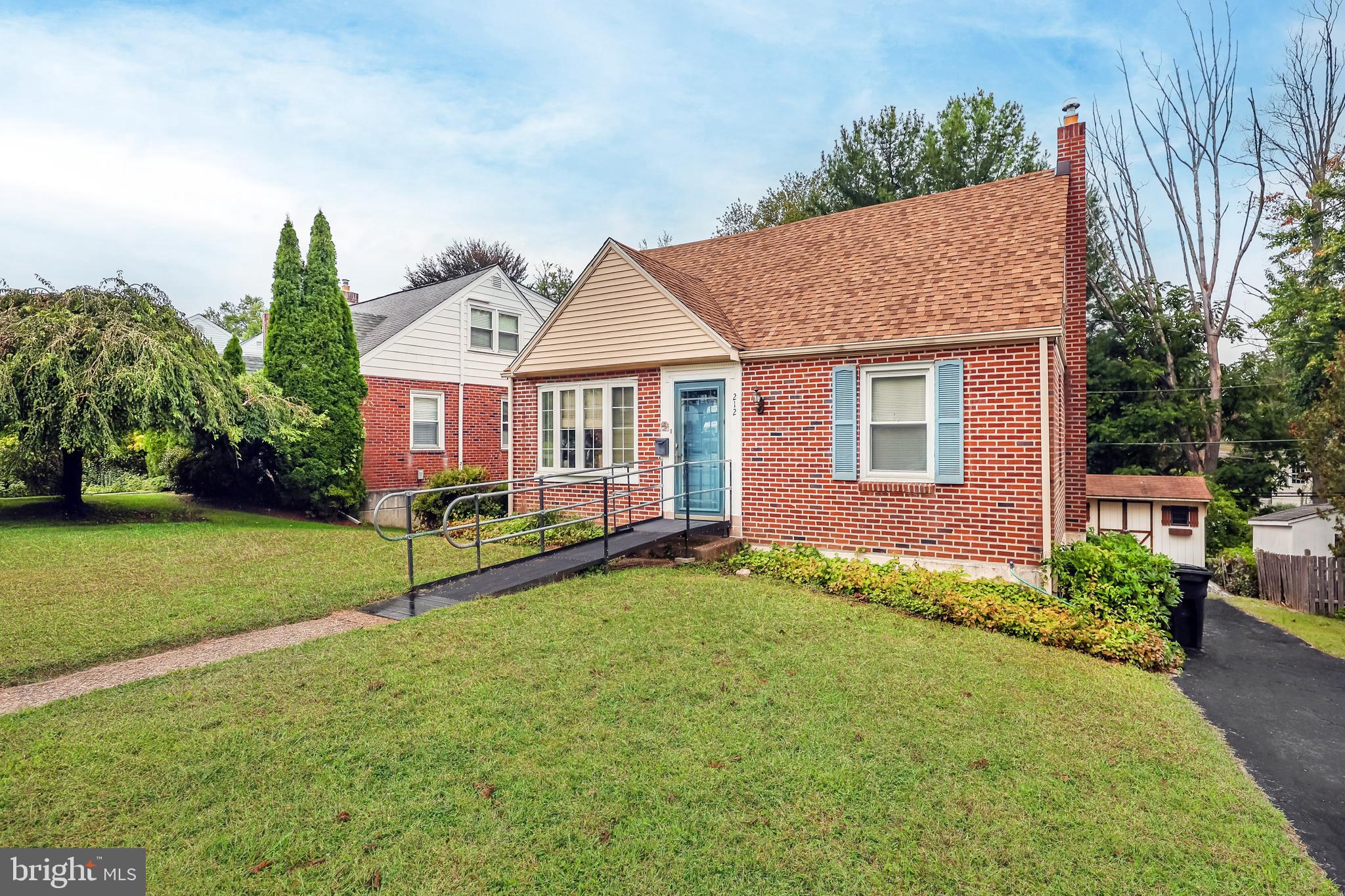 212 Golf Hills Road Havertown, PA 19083 - Photo 3 of 37 a house that has a table and chairs in front of it
