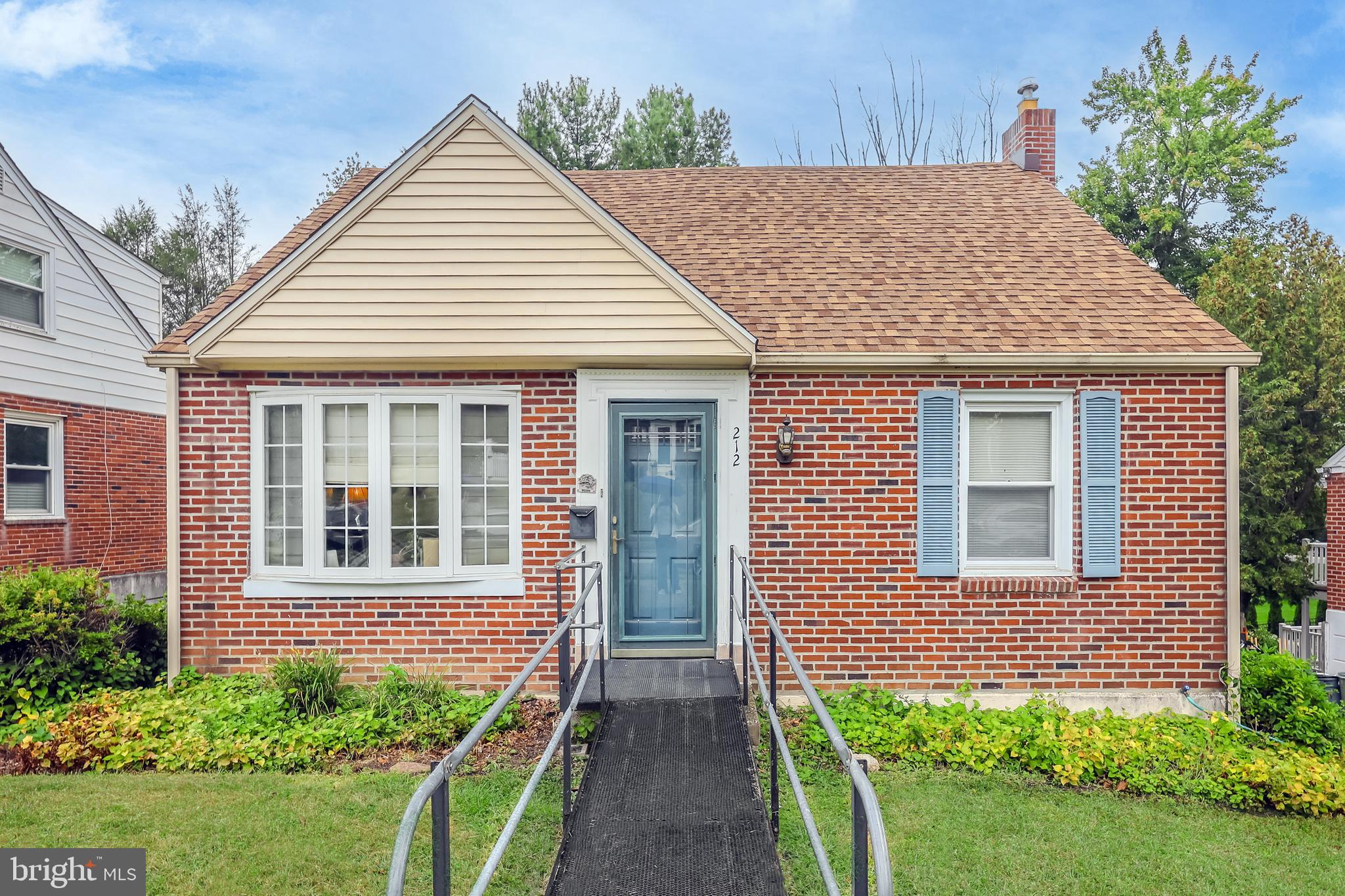 212 Golf Hills Road Havertown, PA 19083 - Photo 4 of 37 a view of a house with brick walls and flower plants